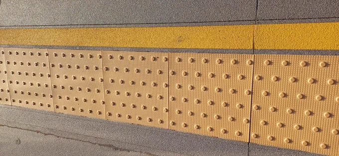 Tactile paving on platform below yellow line to help keep everyone safe and away from railway track