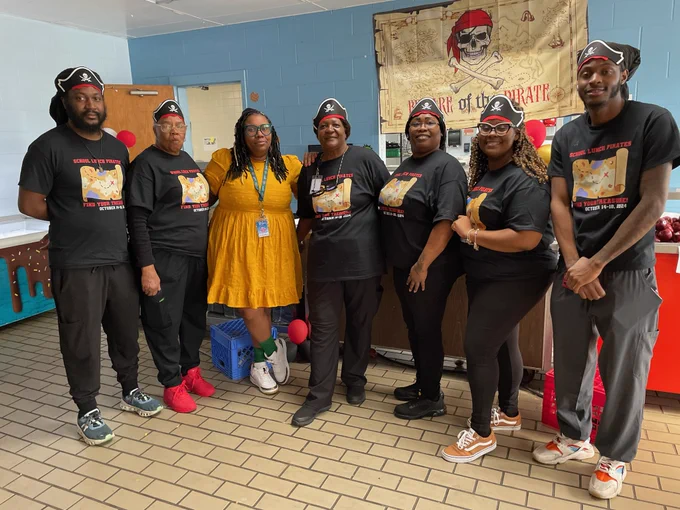 Cafeteria Workers and School Principal pose in Cafeteria kitchen for photo celebrating National School Lunch Week.