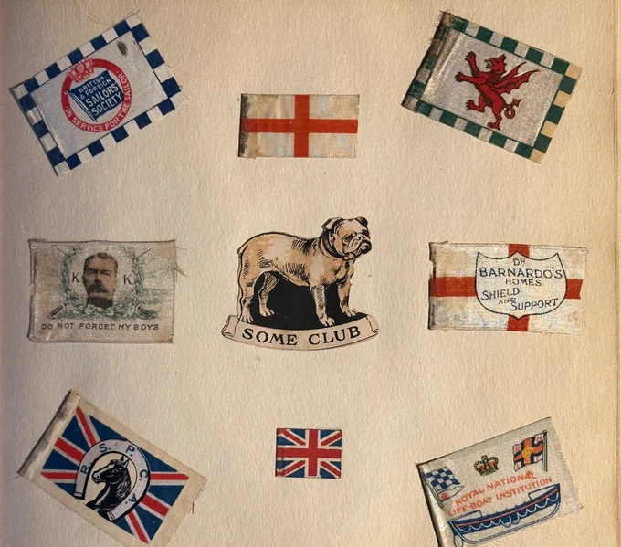 Page from a small scrapbook of badges from WWI to WWII