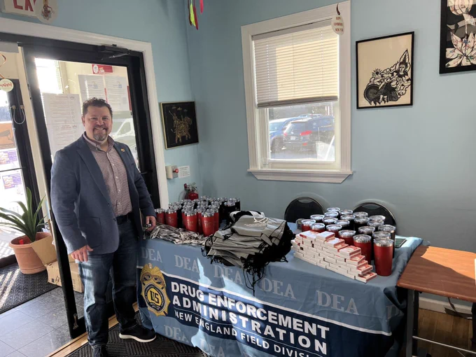 Community outreach specialist, Brian Okeefe standing at the DEA table