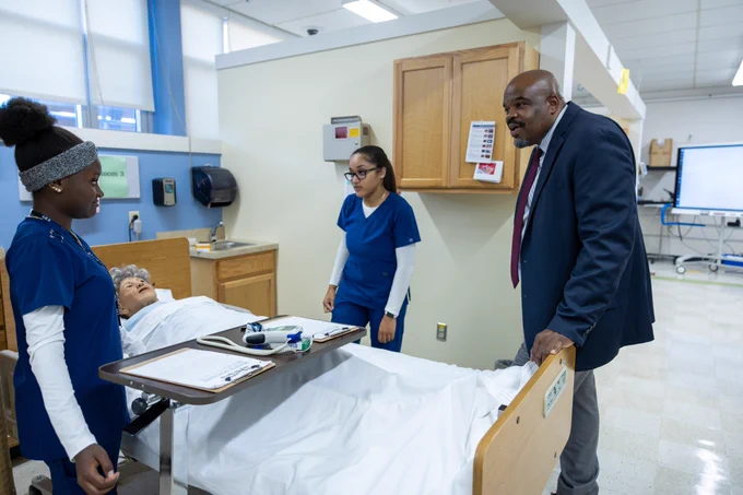 Education Secretary Tutwiler speaks watches a demonstration by students studying nursing working with a lab simulated patient.