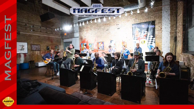 A photo of The Blueshift Big Band is displayed. They perform inside of a gallery lined with art, exposed brick, and bright lights. Approximately 17 members are featured here across several instruments