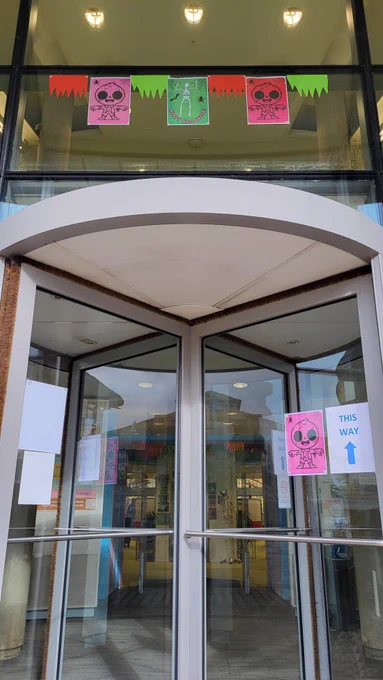 Photo of Moore library entrance with halloween posters (zombies, skeletons etc.)