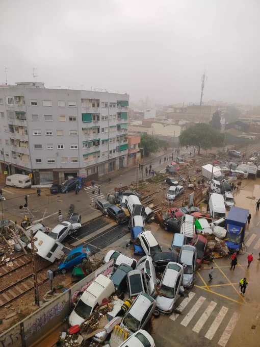 Smashed up cars piled on top of each other in the streets