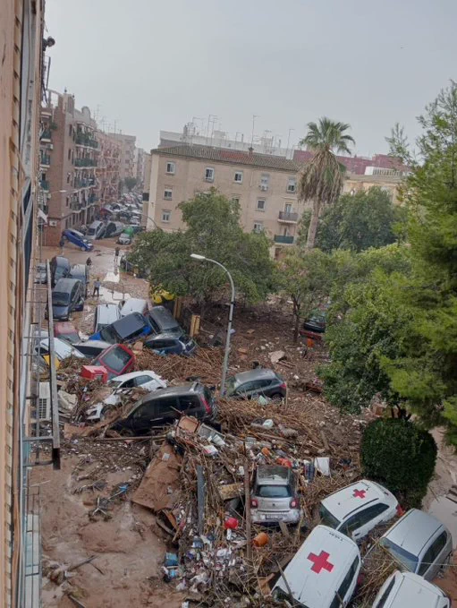 Smashed up cars piled on top of each other in the streets