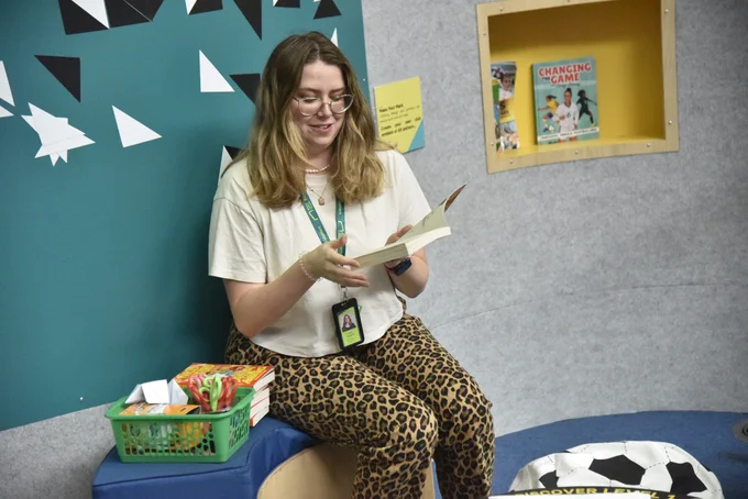 A member of the National Football Museum team reading from a book.