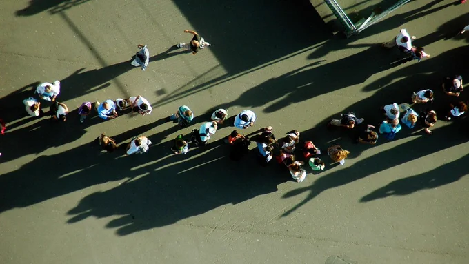 People standing in a queue.