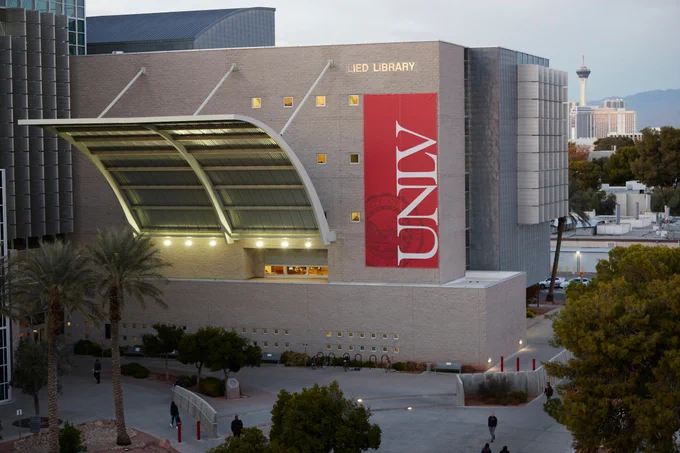 A five-story library building with a red UNLV banner