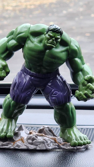 Incredible Hulk action figure attached to a dashboard.