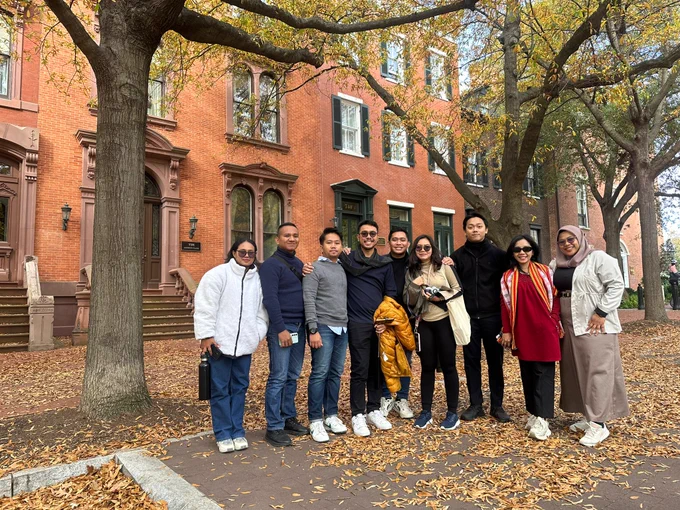 Indonesian participants of the U.S. Department of State's International Visitor Leadership Program (IVLP) stand for a group photo on a street in Washington, DC in October, 2024.