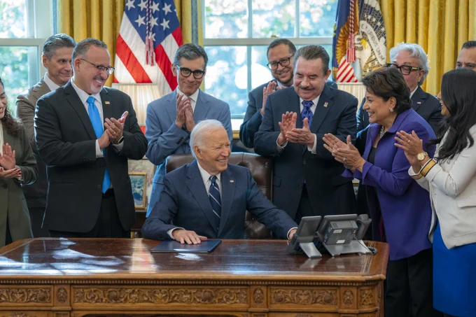 President Biden and others gather in the Oval Office to celebrate the first-ever commission and President’s Advisory Board for HSIs.