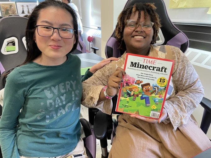 Students holding Time Magazine's special edition on Minecraft.