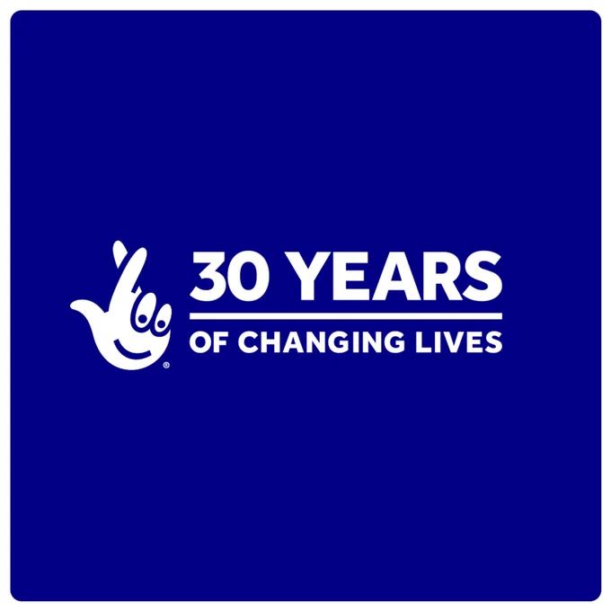 A royal blue background.  The National Lottery logo sits centrally with white text that reads 30 years of changing lives.