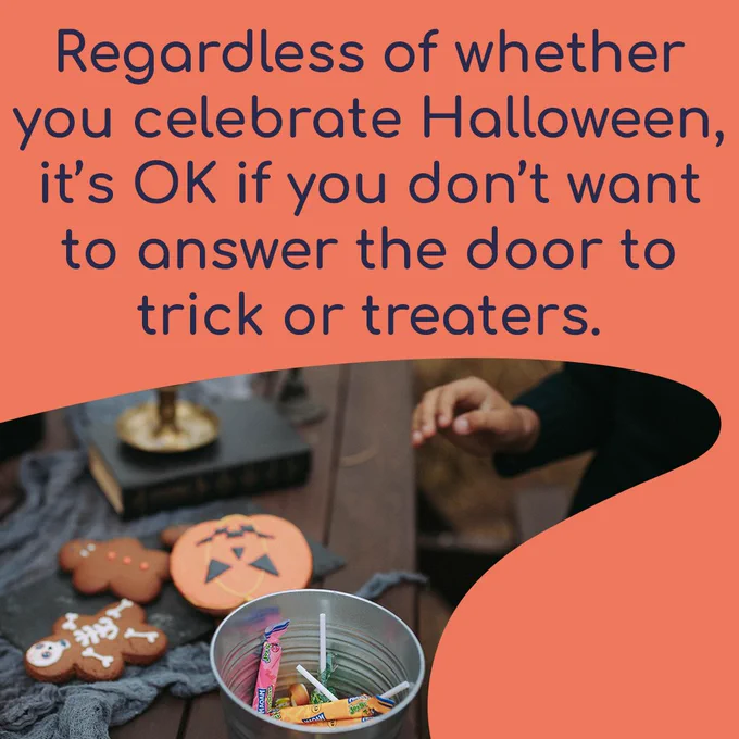 Regardless of whether you celebrate Halloween, it’s OK if you don’t want to answer the door to trick or treaters. The background is a photo of a Halloween table with decorated biscuits and a bucket of sweets. 