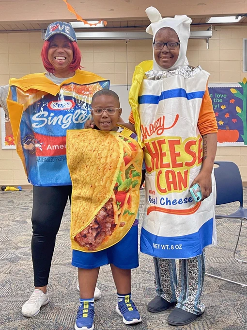 A family dressed as a pack of Kraft singles, a can of spray cheese, and a taco