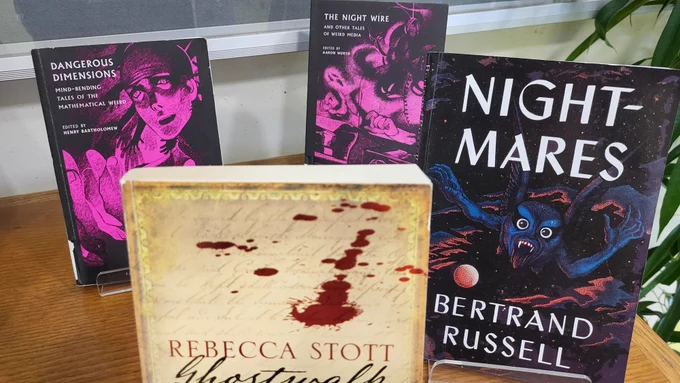 Photos of the Moore Library Halloween book display, various tales of the supernatural