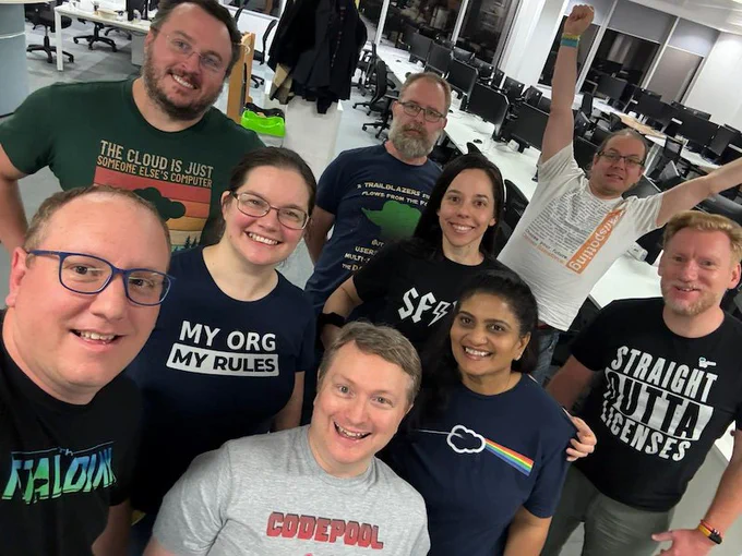 A group of gorgeous, smiling folk in a selfie pose. They're all wearing t-shirts from Shirtforce.org that have funny Salesforce related designs on them.