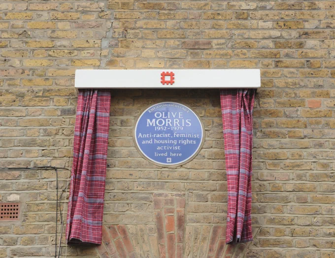 The English Heritage blue plaque for Olive Morris complete with Jamaican tartan curtains for the unveiling that took place on 30th October.