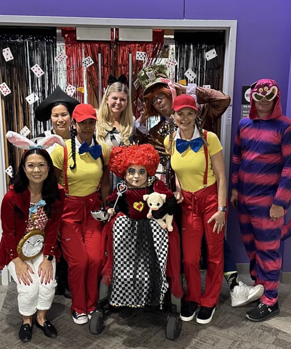 Group picture of providers in Alice in Wonderland costumes