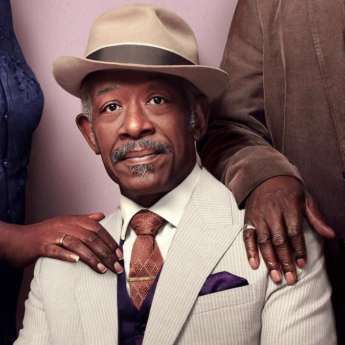 Lennie James as Barrington Walker, a smartly dressed 75-year-old. One one shoulder is the hand of his wife Carmel, on the other the hand of his life-long friend and lover Morris.