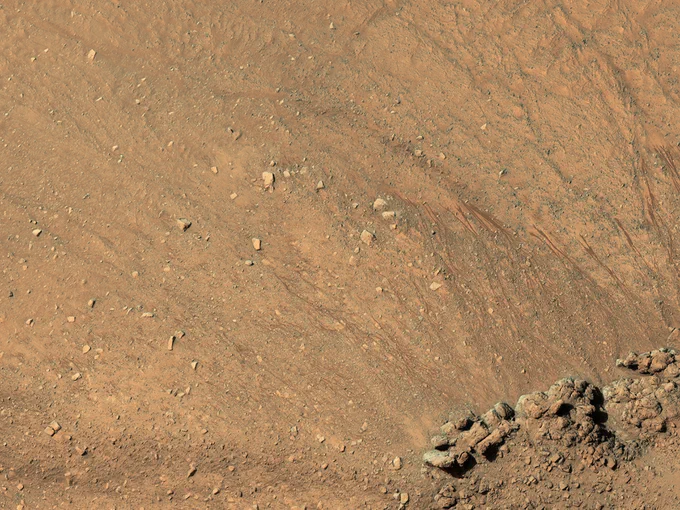 Gullies have formed along slopes both in the ring-depression and within the central pit. A closeup shows gullies and recurring slope lineae (RSL) along the eastern slope of the pit. (NASA/JPL-Caltech/University of Arizona)