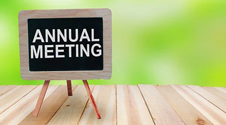 sign on a table that says Annual Meeting