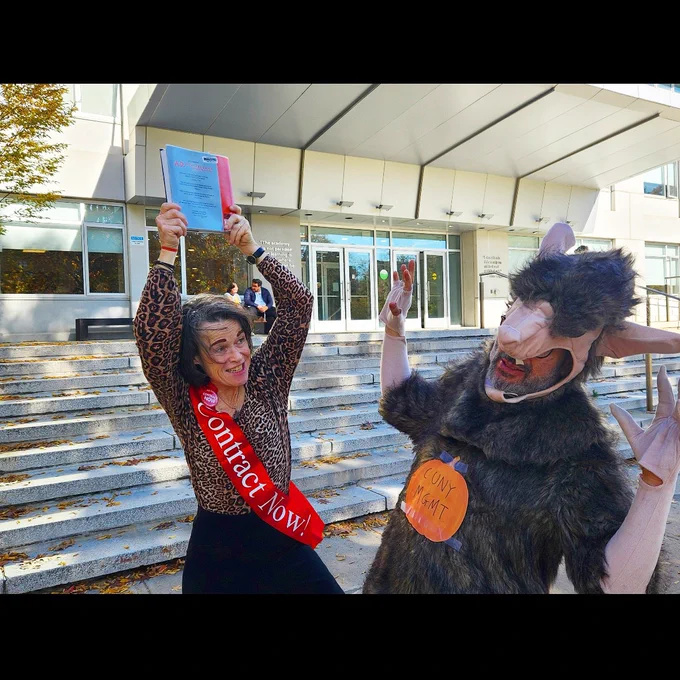 In this photo, a PSC-CUNY member wearing a sash that reads “Contract Now” battles someone wearing a monster costume labeled “CUNY Management”