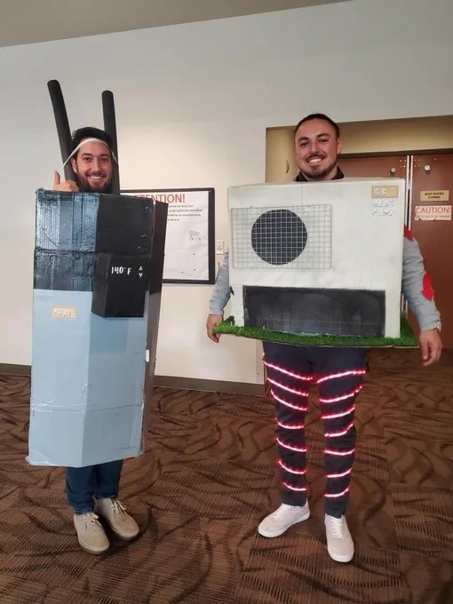 Two city employees dressed up as a heat pumps