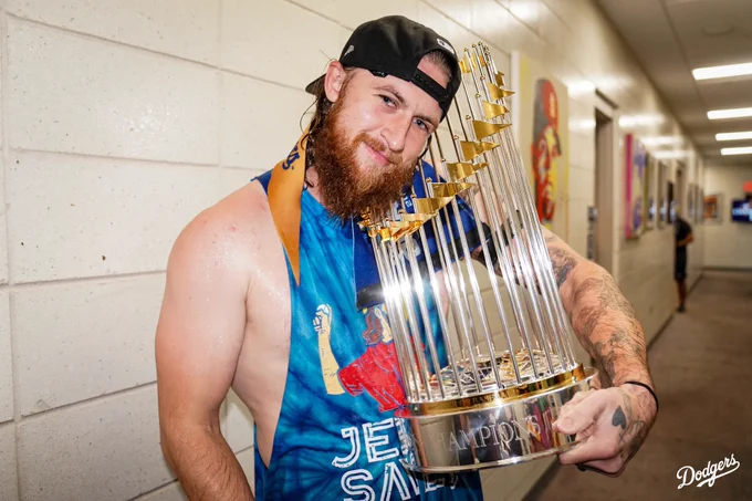 Michael Kopech poses for a photo while holding the World Series trophy.