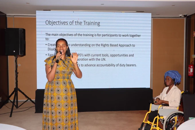 Yetneberesh facillitating the session with her PowerPoint slides at the back.