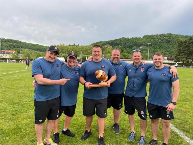 Darren holds the winning trophy alongside his assistant coaches and team managers after England Students were victorious with a 25-21 win over France Universities in May 2023 at the Stade André Beaudry, Terrasson-Lavilledieu.