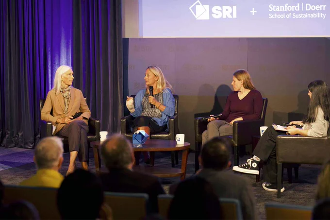 A panel of speakers on stage