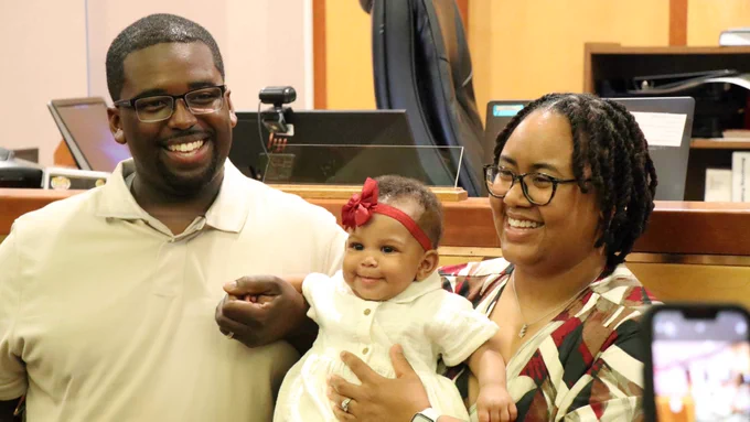 Stephanie and Javon smile as they celebrate the adoption of their daughter, Heavenly Marie, in a Milwaukee courthouse.