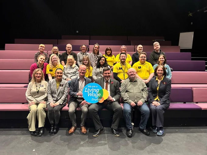 Jamie Hepburn MSP sitting in Cumbernauld theatre with staff