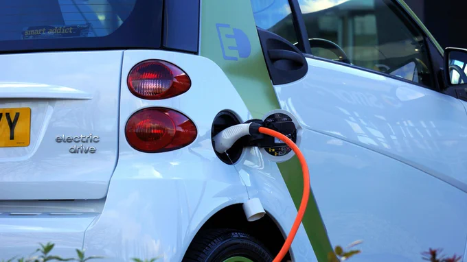 A white electric vehicle charging.