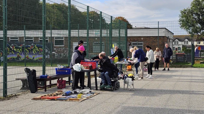 Stalls set up and people having a look at what for sale from a previous boot sale of ours.
