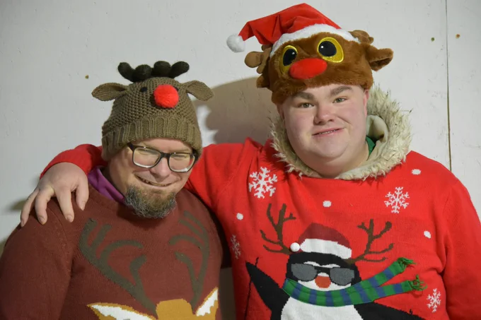Two players posing for a photo together in festive outfits.