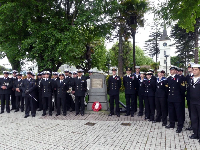 Protector's crew with Chilean sailors at the memorial in Coronel