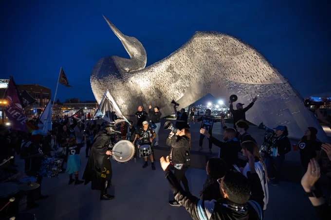 MNUFC supporters gathered in front of the calling loon sculpture with flags and megaphones getting hyped! COYL