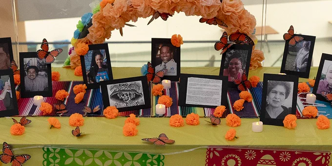 A community ofrenda on the second floor of the Jacobs School of Medicine and Biomedical Sciences has photos and decorations.