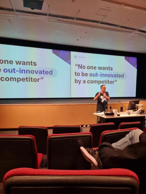 Myles at WordCamp Sydney, slide showing: "No one wants to be out-innovated by a competitor" 