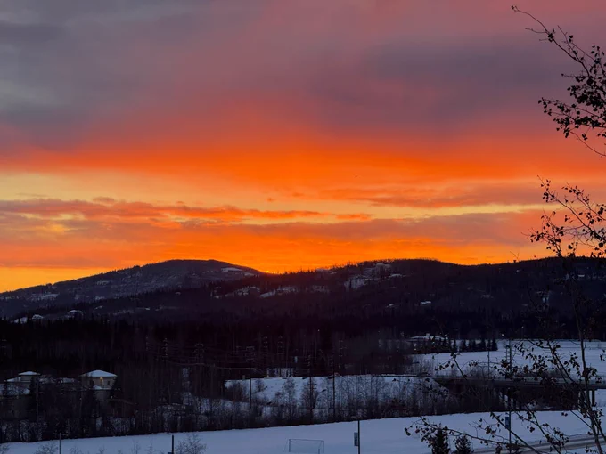 Sunset with bright orange coloration and thin clouds