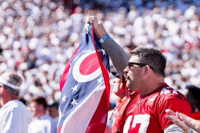 Fan holds state of Ohio flag in the stadium.
