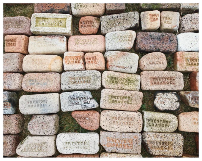 Colour photograph of neatly arranged Prestongrange bricks from the nearby beach