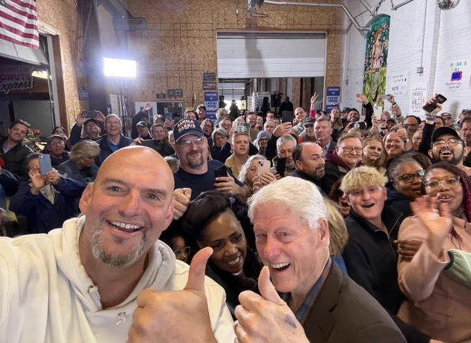 John taking a selfie with former President Bill Clinton and a crowd in Erie County.