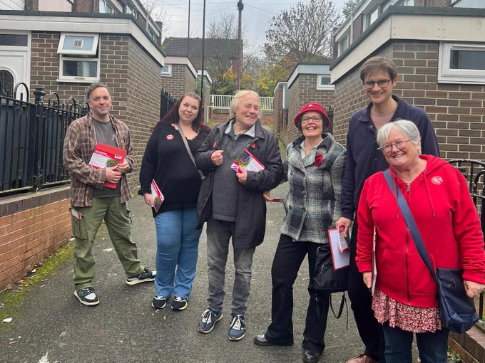 A photo of six Labour Party campaigners standing on a street in Woodhouse
