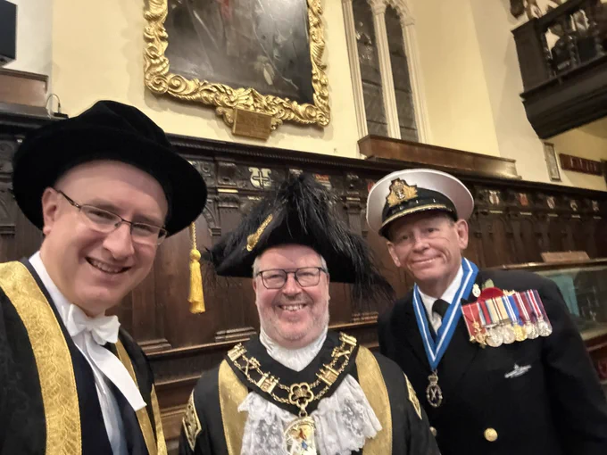 Stuart and the Lord Mayor, both in black and gold robes, next to the High Sheriff in naval uniform