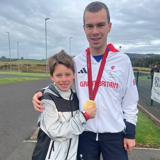 Image of Ben Sandilands and a junior parkrunner