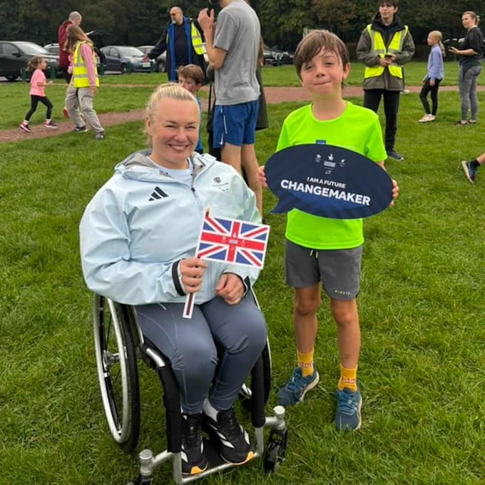 Image of Louise Sugden and a junior parkrunner 