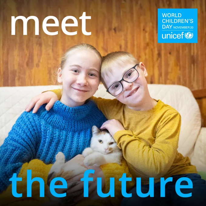 A sister and brother sit closely with their arms around each other, warmly embracing a cat between them with text on visual: ‘Meet the future’.